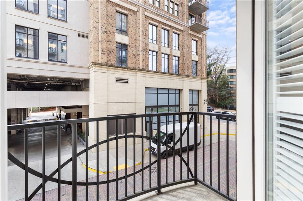 2255 Peachtree Road Northeast, Unit 326 Atlanta, GA 30309 - Photo 19 of 37 a view of a balcony with a floor to ceiling window and wooden floor