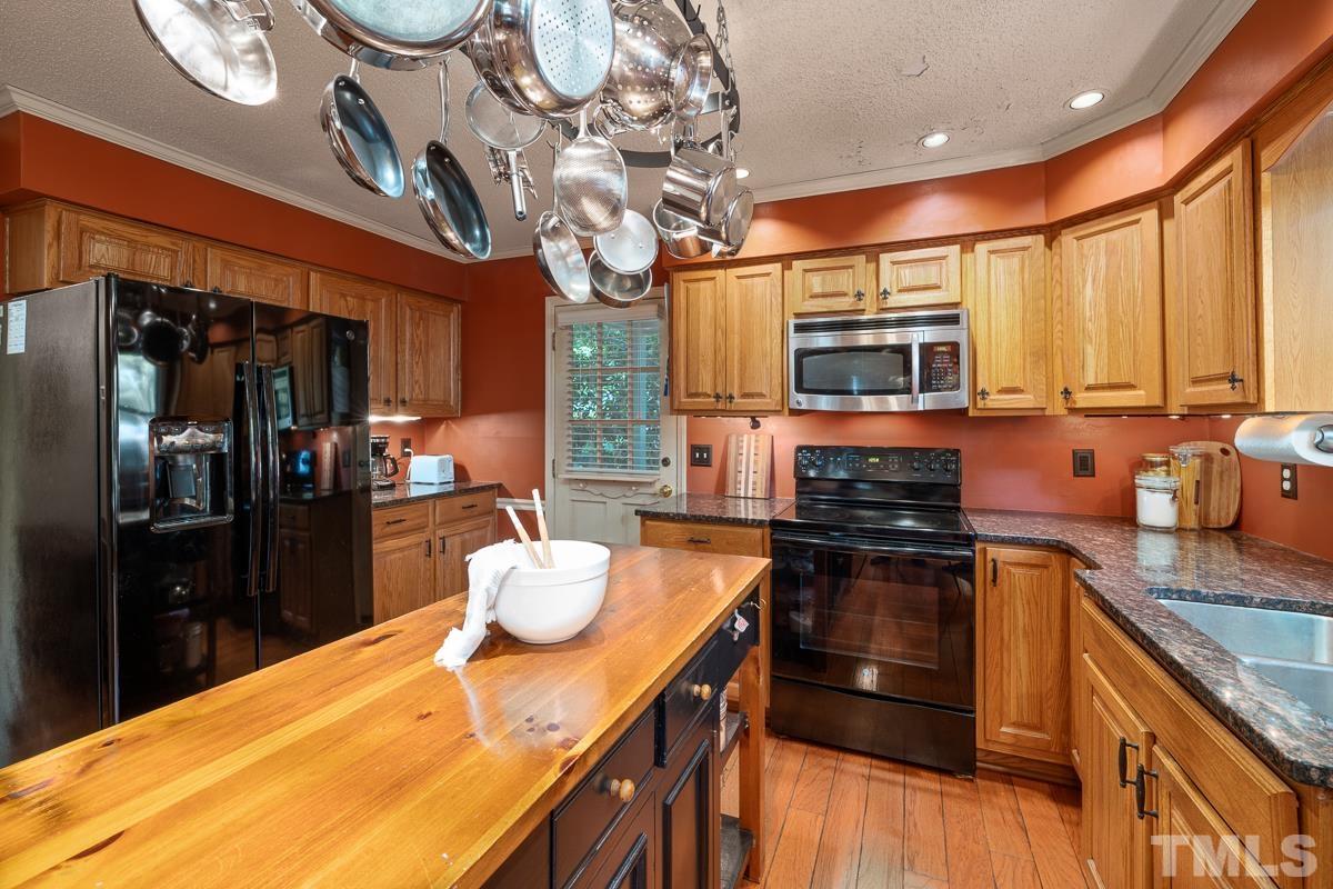 7320 Old Hundred Road Raleigh, NC 27613 - Photo 12 of 39 a kitchen with a sink stove and refrigerator