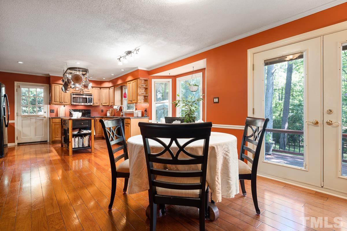 7320 Old Hundred Road Raleigh, NC 27613 - Photo 16 of 39 a view of a dining room with furniture window and wooden floor