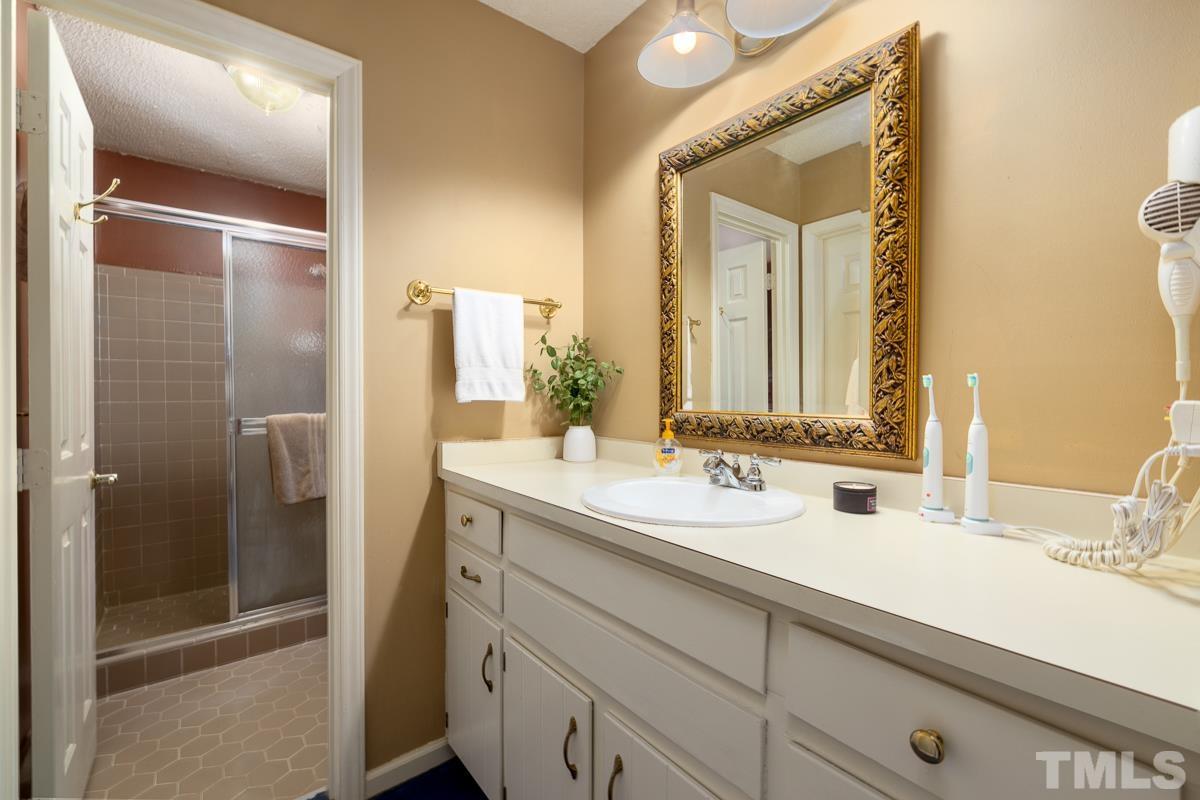 7320 Old Hundred Road Raleigh, NC 27613 - Photo 20 of 39 a bathroom with a double vanity sink and mirror