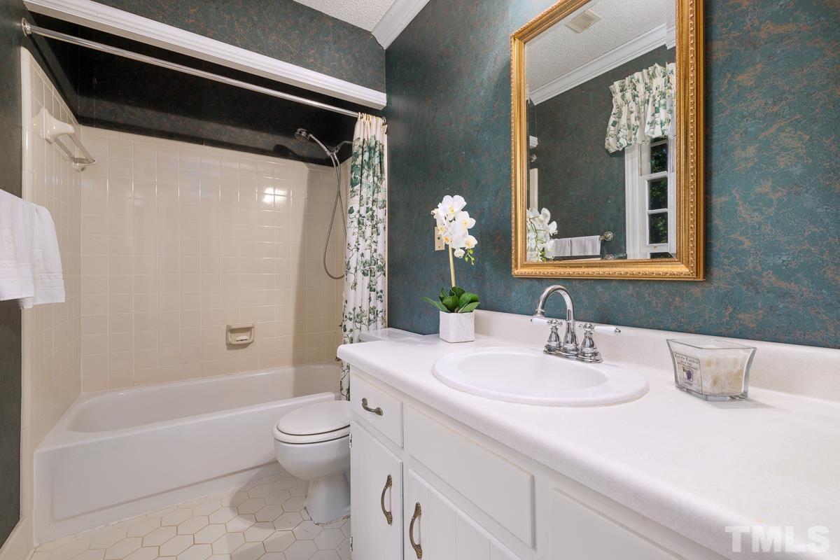 7320 Old Hundred Road Raleigh, NC 27613 - Photo 25 of 39 a bathroom with a sink a toilet and shower