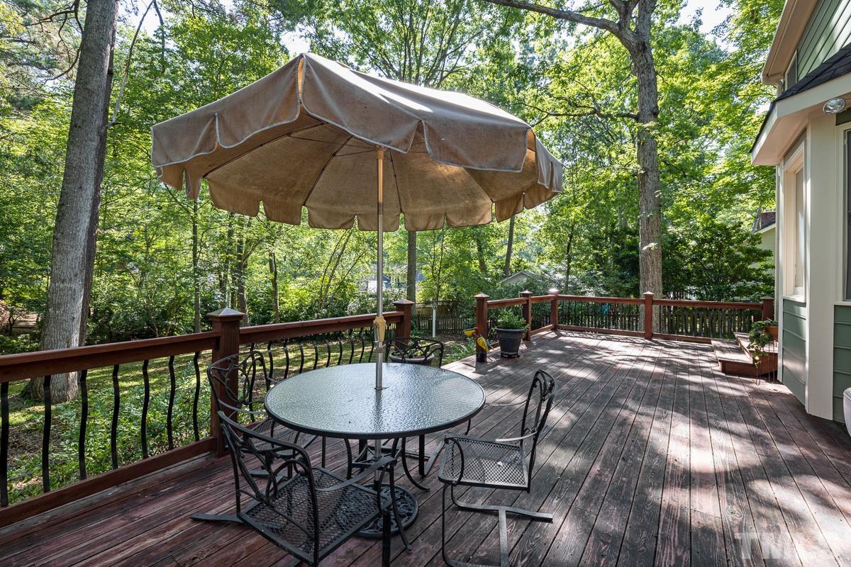 7320 Old Hundred Road Raleigh, NC 27613 - Photo 32 of 39 a view of a table and chairs under an umbrella