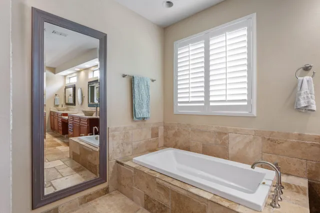 a bathroom with a bathtub and shower