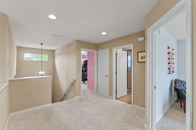 a view of a hallway with closet and window