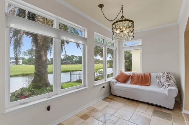 a bedroom with furniture and a large window