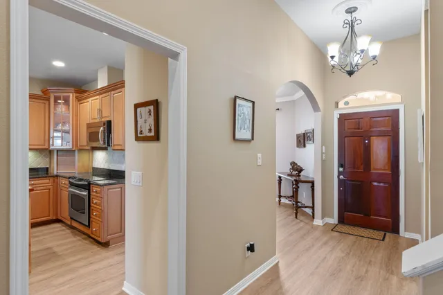 a view of a kitchen with a sink and dishwasher a refrigerator with wooden floor