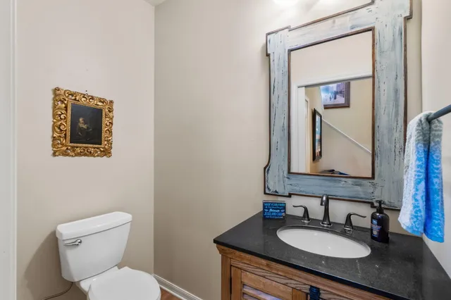 a bathroom with a toilet a sink and mirror