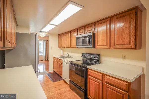 a kitchen with stainless steel appliances granite countertop a sink stove and microwave