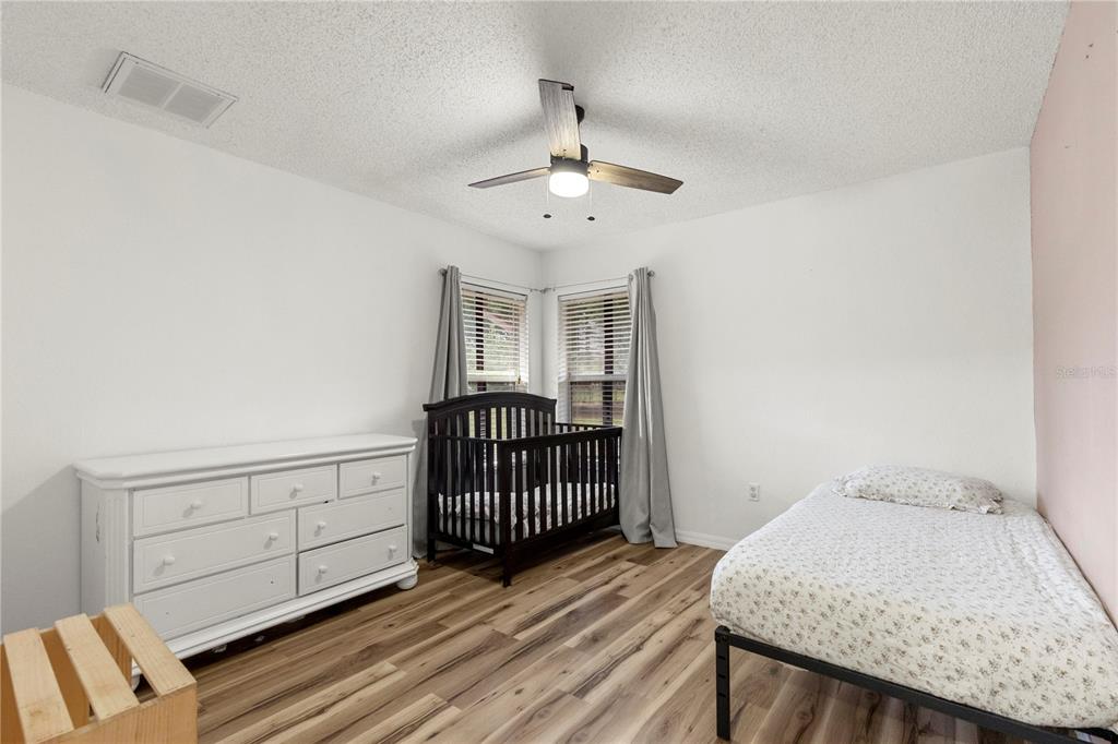 9917 Nelson Road Dade City, FL 33525 - Photo 29 of 40 a view of a room with wooden floor fan and windows