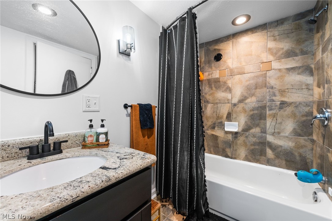 4159 Bluestone Road Cleveland, OH 44121 - Photo 19 of 42 Bathroom featuring shower / bath combination with curtain and vanity