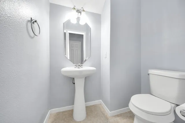 an empty room with windows and fireplace