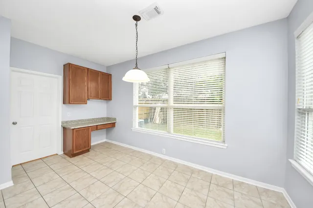 a view of a room with white cabinets