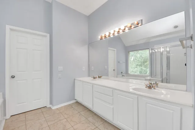 a bathroom with a tub sink and mirror