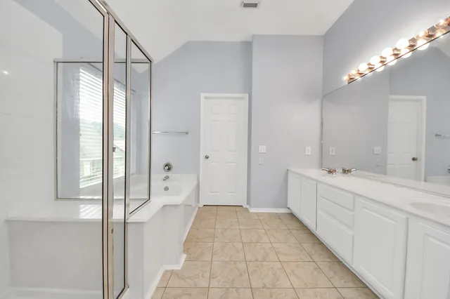 a bathroom with a bathtub and shower