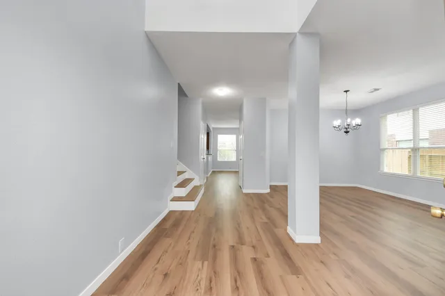 a view of hallway with wooden floor