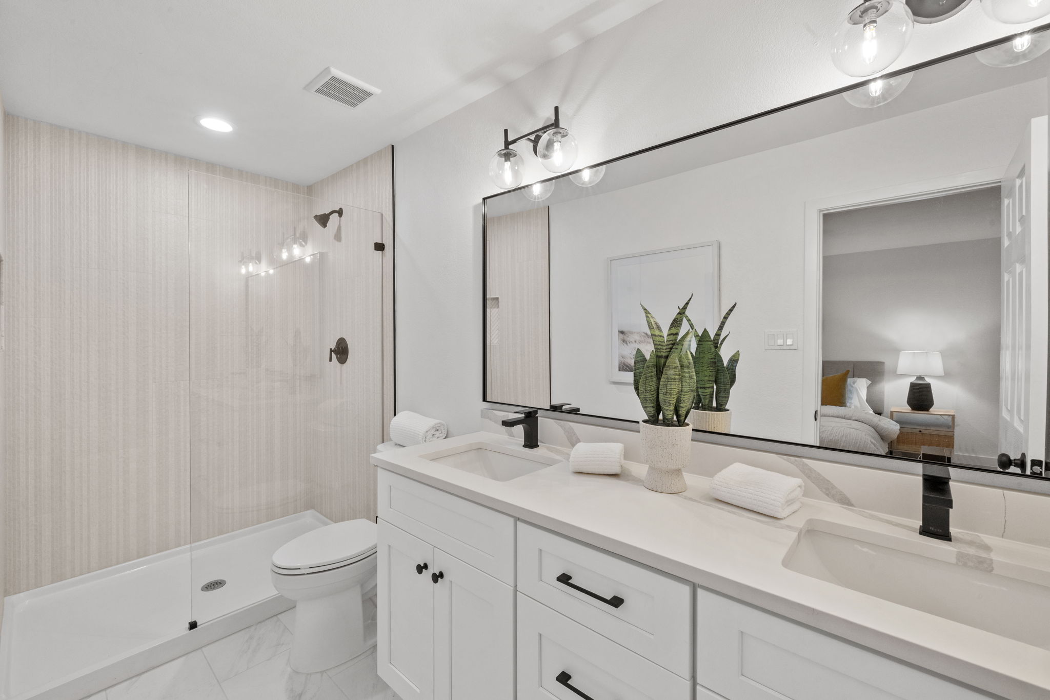 9502 Crown Ridge Road Austin, TX 78753 - Photo 8 of 13 Ensuite bathroom featuring double vanity, a stall shower, light marble look finish floors, and recessed lighting