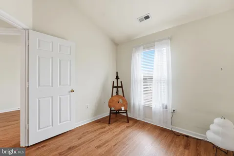 a room that has a window and wooden floor