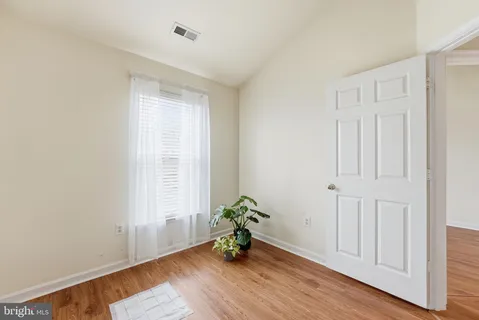 a room with wooden floor and a window