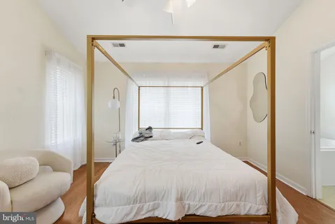 a spacious bedroom with a bed and a couch