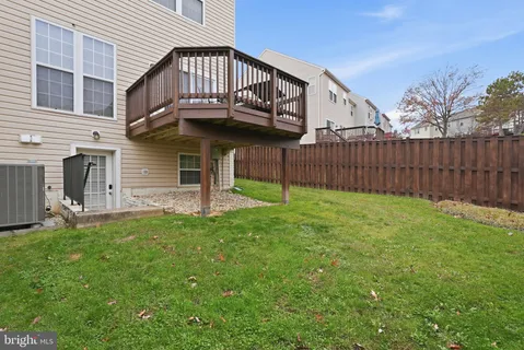 a view of a house with a yard and wooden fence