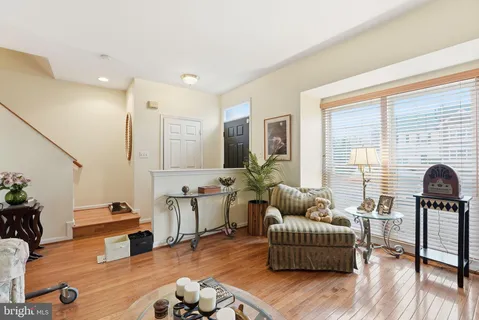 a living room with furniture window and wooden floor