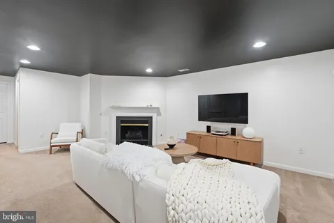 a view of a livingroom with furniture and a flat screen tv