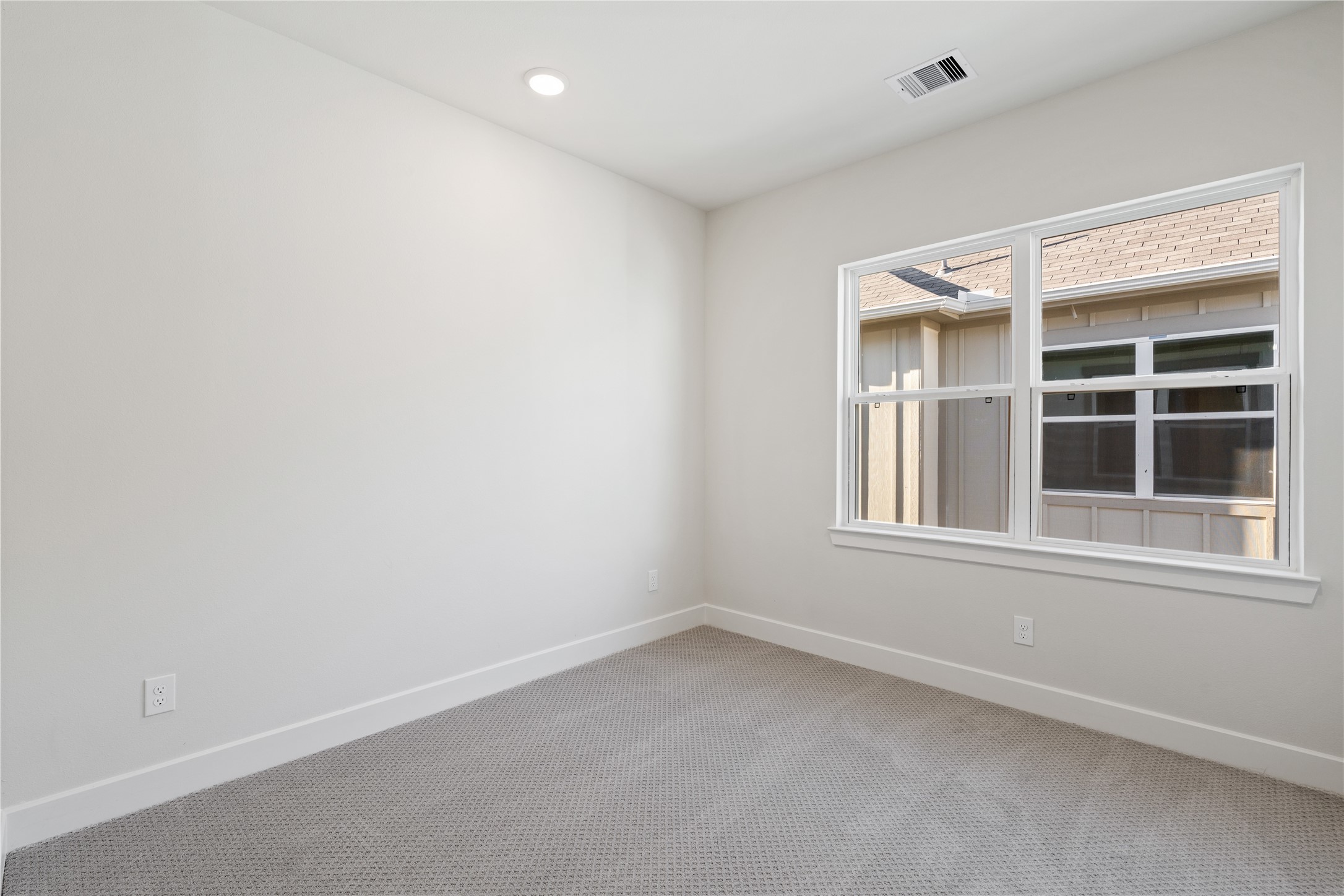 6505 Rena Street Houston, TX 77092 - Photo 24 of 28 Third bedroom with carpeted floors and a side-facing window that keeps the room feeling open without competing with any adjacent room.
