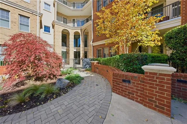 a view of a living room kitchen with furniture and large window