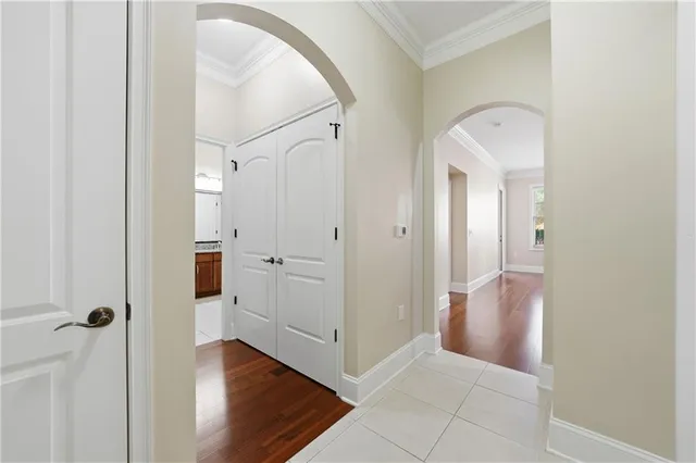 a view of a hallway with closet and a mirror