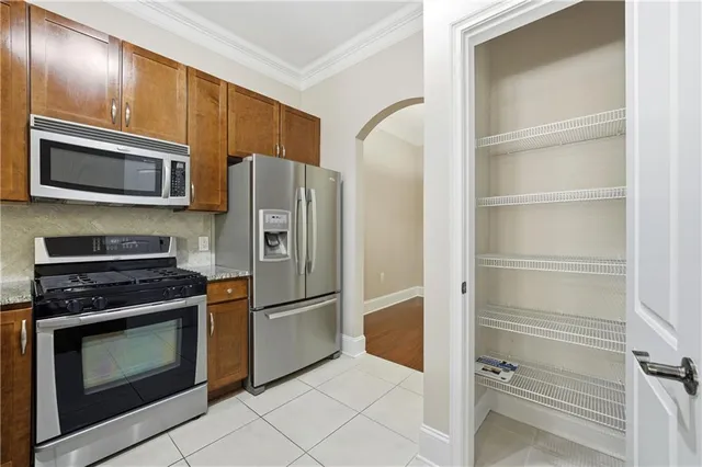 a kitchen with granite countertop stainless steel appliances and counter space