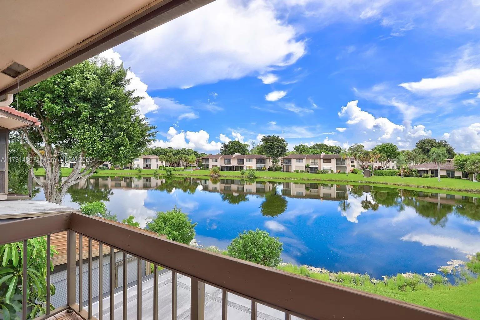21338 Juego Circle, Unit 11C Boca Raton, FL 33433 - Photo 1 of 17 a view of a lake from a balcony