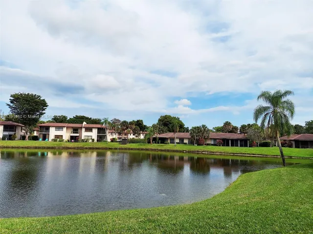 a view of a lake with houses in the back