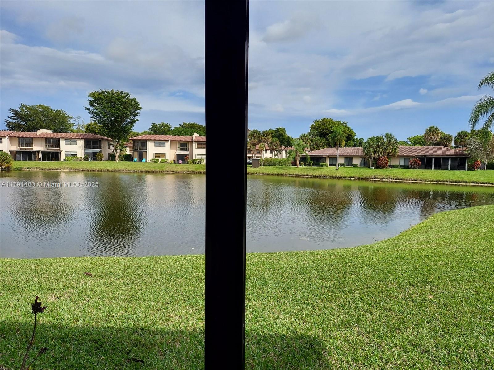 21338 Juego Circle, Unit 11C Boca Raton, FL 33433 - Photo 12 of 17 a view of a lake with houses