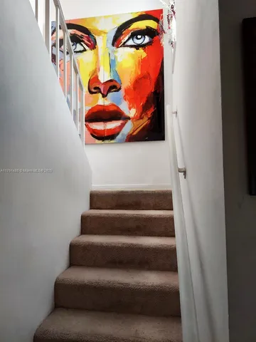 en empty room with windows and chandelier fan