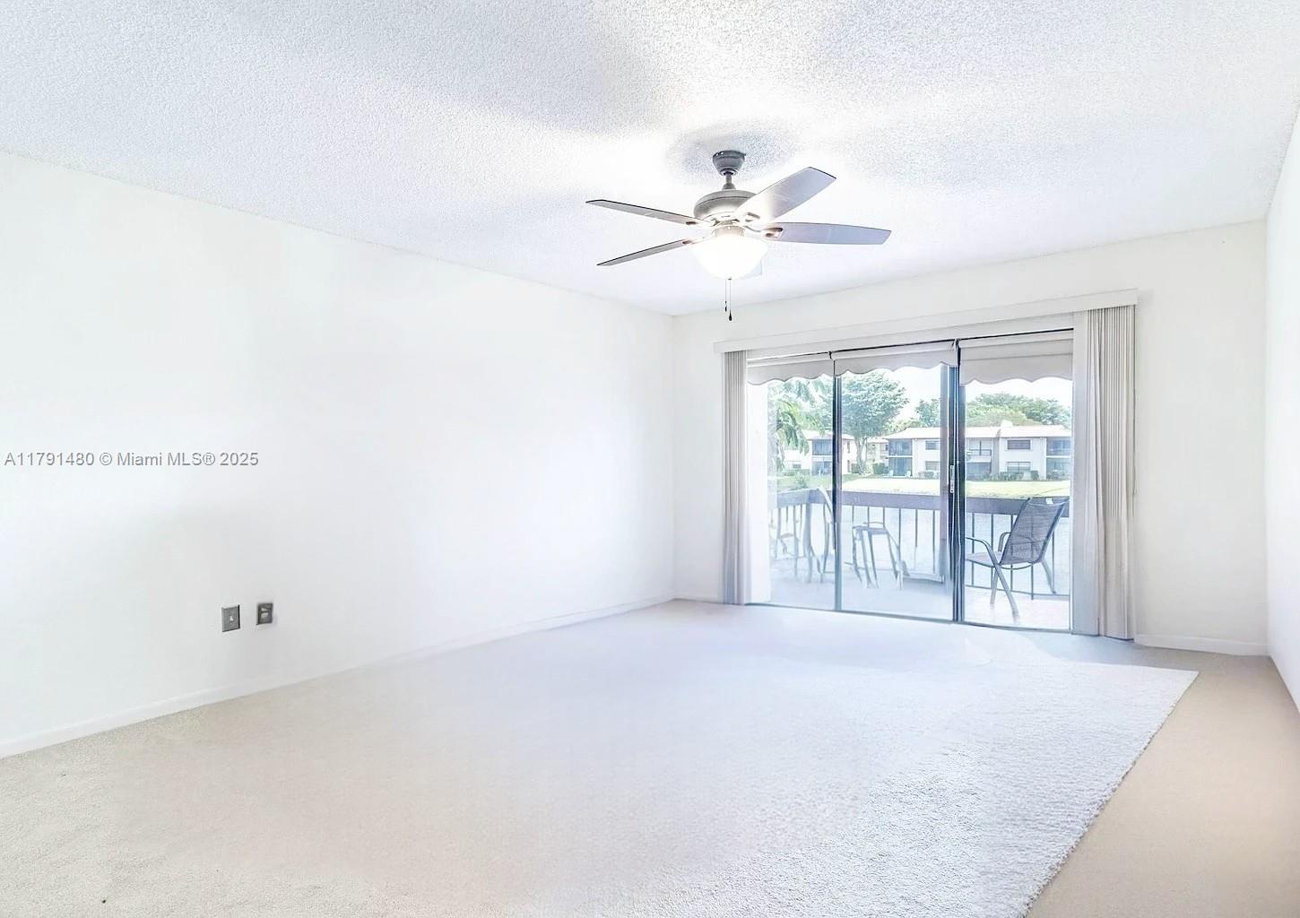 21338 Juego Circle, Unit 11C Boca Raton, FL 33433 - Photo 16 of 17 a view of an empty room with a window