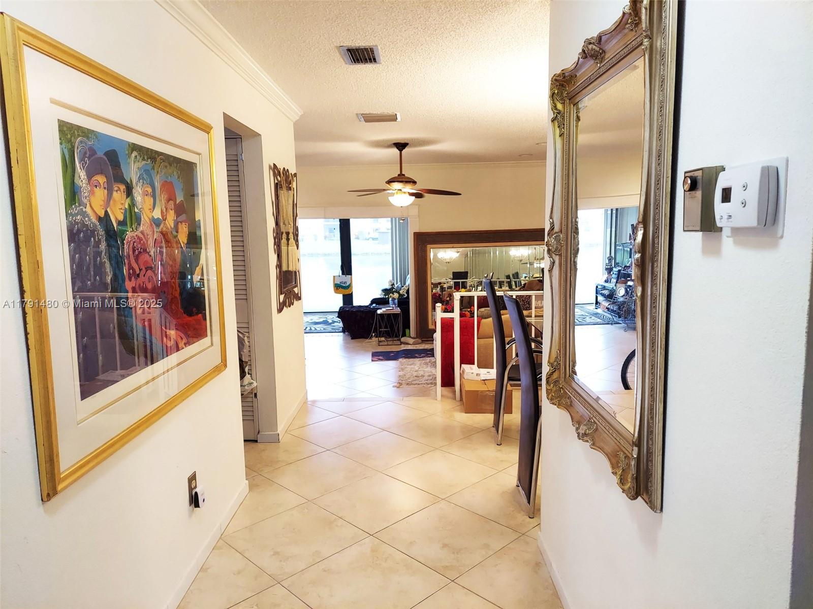 21338 Juego Circle, Unit 11C Boca Raton, FL 33433 - Photo 7 of 17 a view of a hallway with a living room and a hallway