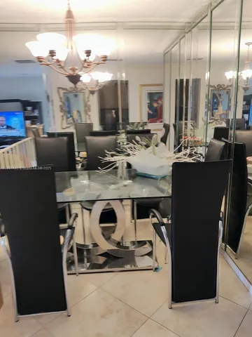 a view of kitchen with kitchen island wooden cabinets and refrigerator