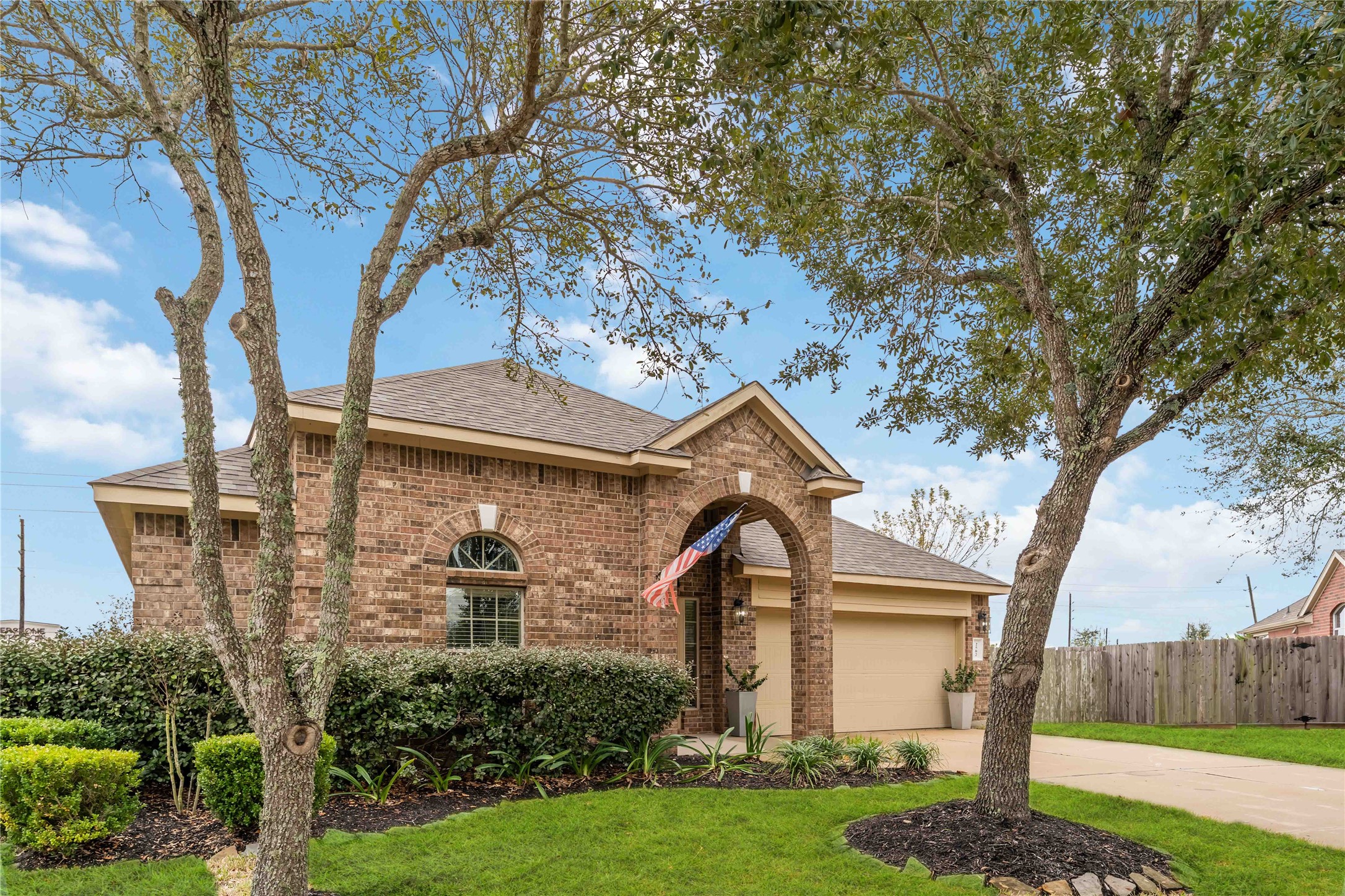 2502 Tiger Eye Drive Rosharon, TX 77583 - Photo 3 of 29 The property features a lush, green front yard with mature trees, providing excellent curb appeal.
