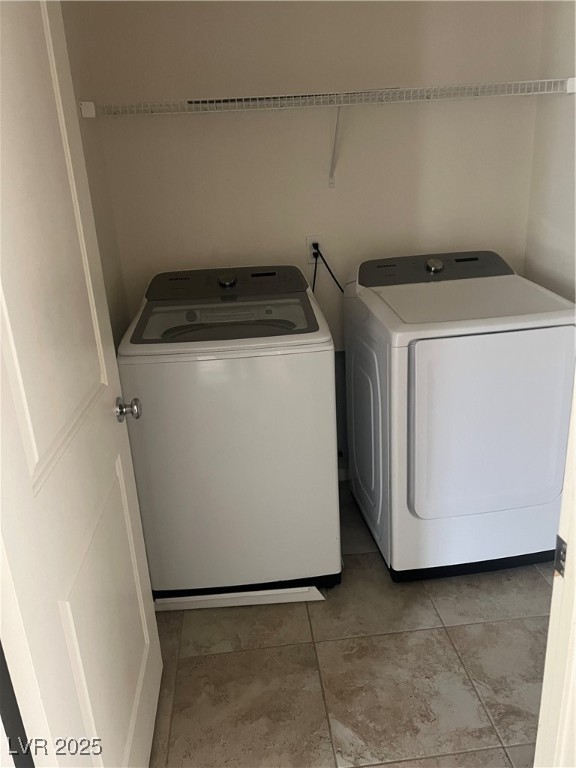 2815 Donatello Manor Place Henderson, NV 89044 - Photo 11 of 14 Laundry area featuring washing machine and clothes dryer and light tile patterned floors