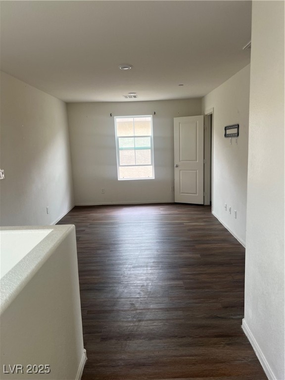 2815 Donatello Manor Place Henderson, NV 89044 - Photo 7 of 14 Empty room with dark wood finished floors and baseboards