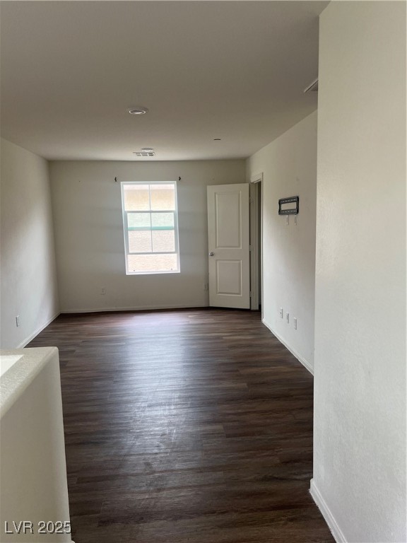 2815 Donatello Manor Place Henderson, NV 89044 - Photo 8 of 14 Empty room featuring dark wood-type flooring and baseboards