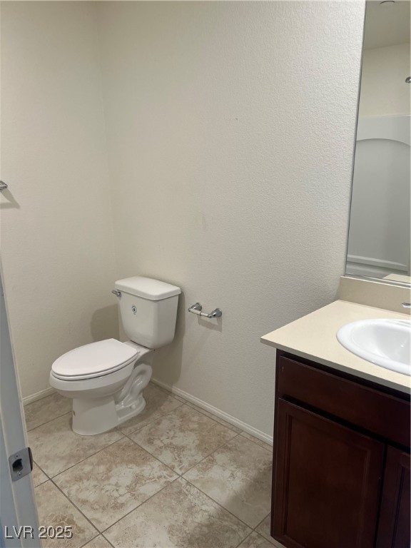 2815 Donatello Manor Place Henderson, NV 89044 - Photo 10 of 14 Bathroom with vanity, a textured wall, and light tile patterned floors