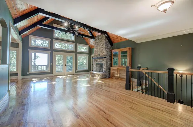 a view of an empty room with a fireplace and a window