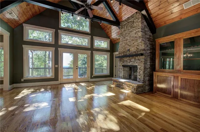 a view of a livingroom with wooden floor and a fireplace
