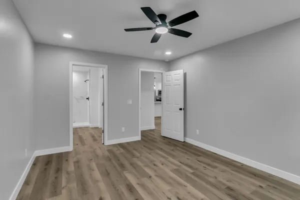 a view of an empty room and wooden floor