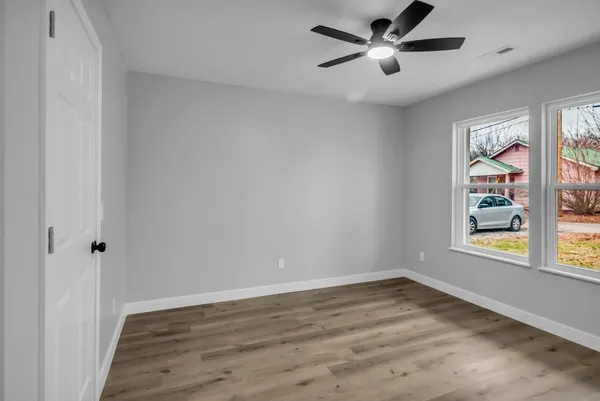 wooden floor in an empty room with a window