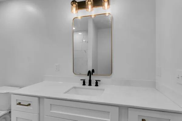 a bathroom with a sink and a mirror