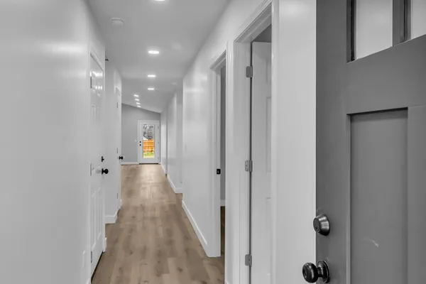 a view of a hallway with wooden floor