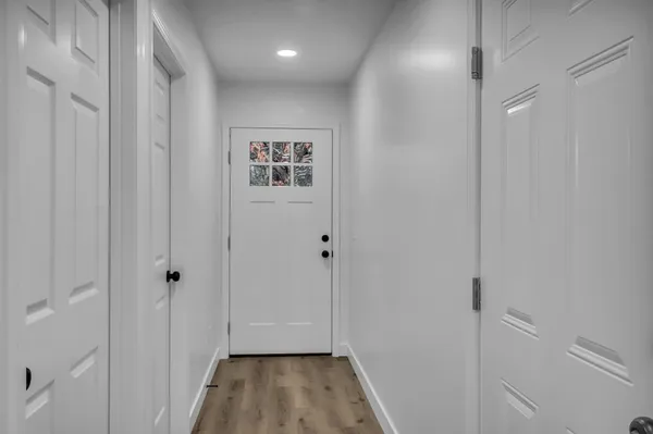 a view of a hallway with wooden floor