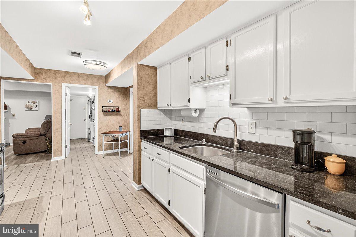 19624 Westerly Avenue Poolesville, MD 20837 - Photo 11 of 44 a kitchen with stainless steel appliances granite countertop a sink and cabinets